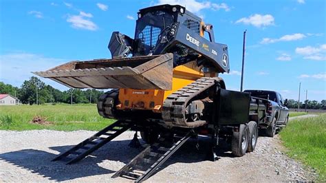 dump truck pulling trailer with skid steer|low ground skid steer trailers.